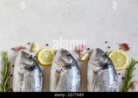 Two fresh raw sea organic dorado or sea bream with spices and lemon Stock Photo