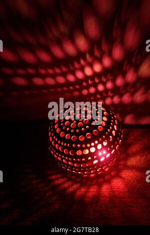 Red light inside a DIY coconut shell lamp Stock Photo