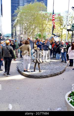 Fearless Girl bronze statue in the financial district in lower Manhattan area of New York City, NY, USA  This is the previous location on Broadway. Stock Photo