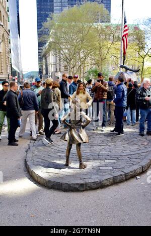 Fearless Girl bronze statue in the financial district in lower Manhattan area of New York City, NY, USA  This is the previous location on Broadway. Stock Photo