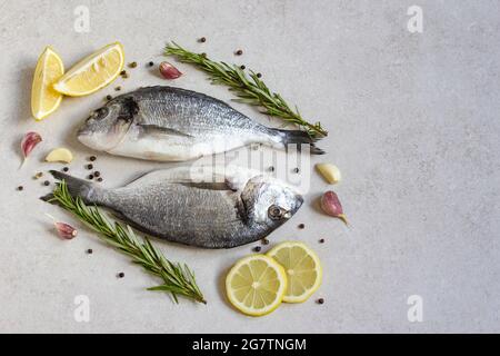 Two fresh raw sea organic dorado or sea bream with spices and lemon Stock Photo