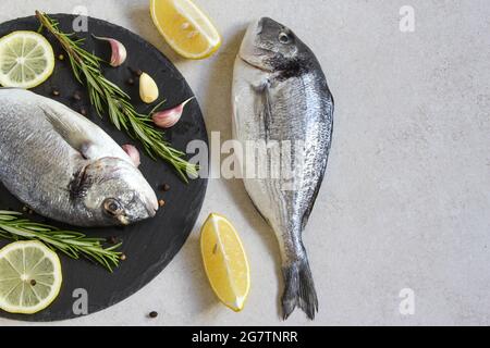 Two fresh raw sea organic dorado or sea bream with spices and lemon Stock Photo