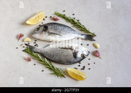 Two fresh raw sea organic dorado or sea bream with spices and lemon Stock Photo