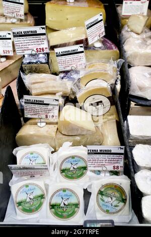 Display case of cheese at Murray’s Cheese Flagship store on Bleecker Street in Greenwich Village, New York City.  Opened in 1940. Stock Photo