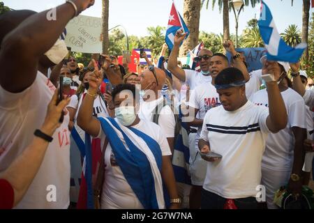 Malaga, Spain. 16th July, 2021. Protesters making gestures and chanting slogans as they take part in a demonstration in support of Cuban population. A group of Cuban residents in Malaga have marched along main streets in downtown under the slogan: 'Homeland and life' to demonstrate against government of Cuban president Miguel Diaz Canel, after social breakdown in Cuba demanding the end of the communist dictatorship. (Photo by Jesus Merida/SOPA Images/Sipa USA) Credit: Sipa USA/Alamy Live News Stock Photo