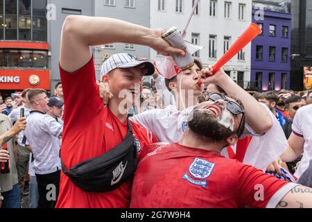 English football fans pour beer before the England vs Italy Euro 2020 final, Leicester Square, London, 11 July 2021 Stock Photo