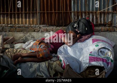 A poor hungry man is sleeping on sack. Stock Photo
