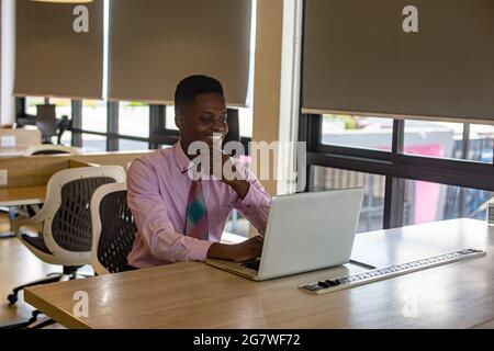 Portrait of a young African  American man and girl working at a laptop in a cafe during a coffee break. A break, relax Stock Photo