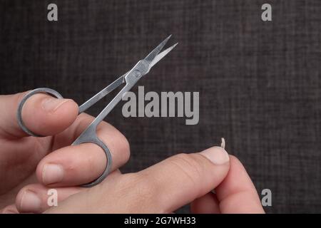 nail clipping with nail scissors closeup. Stock Photo