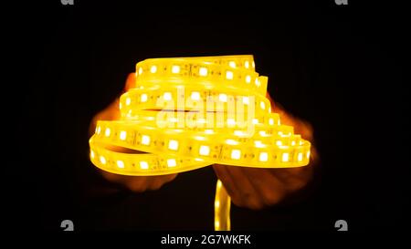 a roll of shining LED strip in dark. Stock Photo