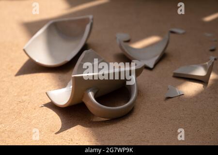 broken mug on the floor close-up. Stock Photo