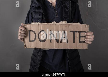 woman asks for help with donation sign. Stock Photo