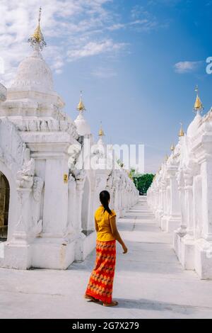 Mandalay Myanmar, Tourist among of stupas in Kuthodaw Pagoda, known as the world's largest book. Kuthodaw is a Buddhist stupa, located in Mandalay, Burma Myanmar Stock Photo