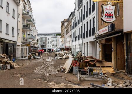 Bad Neuenahr, Germany. 16th July, 2021. Objects destroyed by the flood lie in a street whose pavement was also washed away. Massive rainfall caused flooding in Bad Neuenahr in Rhineland-Palatinate as well as in the entire district of Ahrweiler. Credit: Philipp von Ditfurth/dpa/Alamy Live News Stock Photo