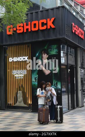 Beijing, China. 16th July, 2021. Two pedestrians in front of CASIO G-Shock  store. (Photo by Sheldon Cooper/SOPA Images/Sipa USA) Credit: Sipa  USA/Alamy Live News Stock Photo - Alamy