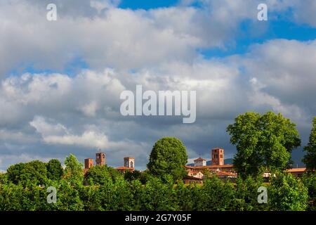 Lucca charming historic center skyline with medieval towers rises above surrounding anciet walls park trees Stock Photo