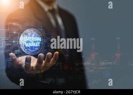Emerging Markets, Internet technology business concept and network A young businessman who works on a virtual screen of the future and sees the inscri Stock Photo