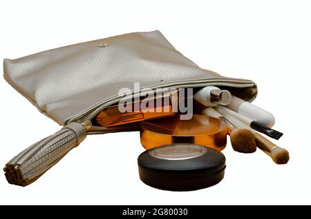 Cosmetic bag with beauty accessories and makeup products isolated with white Stock Photo