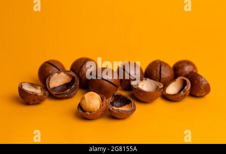 split macadamia nut close-up on an orange background. Stock Photo