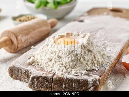 flour and egg yolk on white kitchen table Stock Photo