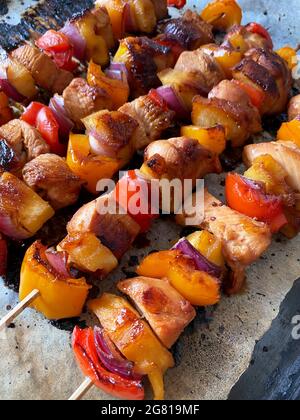 grilled chicken and vegetables skewers on baking pan Stock Photo