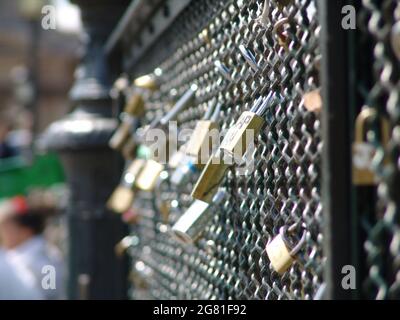 Selective focus shot of padlocks on a fence Stock Photo