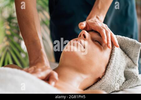 Deep relaxing ayurvedic head, face and chest massage Stock Photo