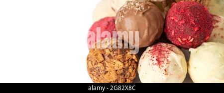Homemade candies isolated on a white background closeup. Energy balls with chocolate, nuts, berries and karkade. Superfood. Copy space. Stock Photo