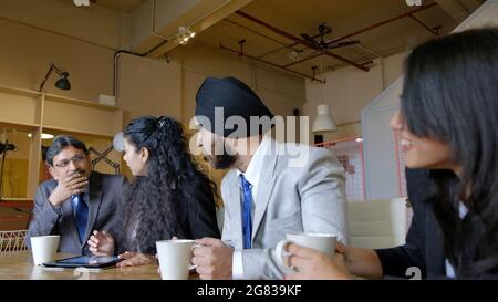 Constructive discussion between colleagues during break time in the office Stock Photo