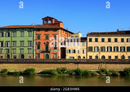 Colorful facades of historical houses Pisain. Arno river and traditional italian architecture. Cityscape, old town district. Summer day, Tuscany. Stock Photo