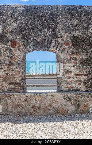 An old city wall window to the sea, Cartagena de Indias, Colombia. Stock Photo