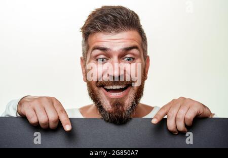 Bearded man hold black friday sale banners. Black friday text. Close-up portrait. Background black friday. Ready for text, slogan or product. Stock Photo