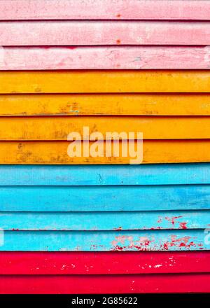 Colourful textured background of colourful, distressed horizontal wooden slats. Stock Photo