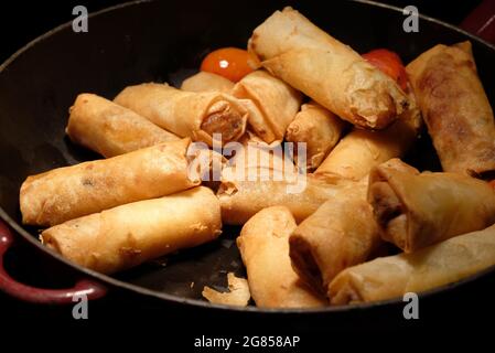deep fried spring rolls  surve on the pan in dark background Stock Photo