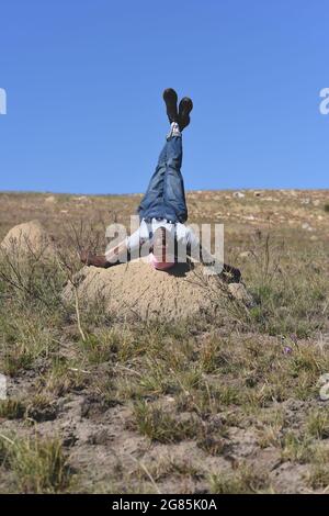 Portrait of young man laying on his back while looking at camera Stock Photo