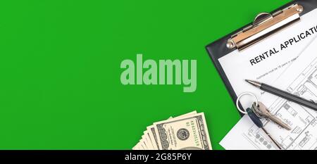 Rental form on clipboard. Office desktop with contract, money, house keys and pen. Green background, top view photo Stock Photo
