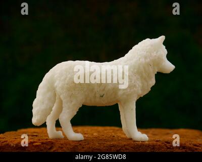 White color fox toy animal presentation at natural green wall backdrop, kids playing object natural image. Stock Photo