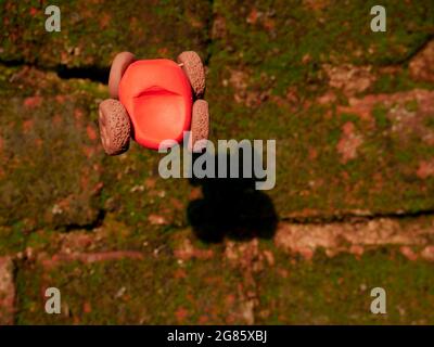 Amazing clay toy car presented on wall with near shadow view. Stock Photo