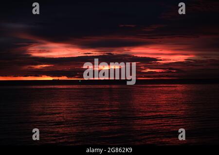 Sophisticated bloody sunset over empty Pattaya bay, Thailand, during third wave of COVID-19
