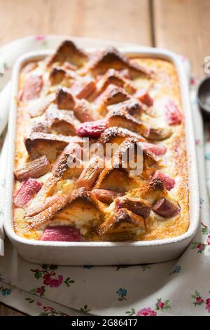 Rhubarb ricotta bread and butter pudding with icing sugar Stock Photo