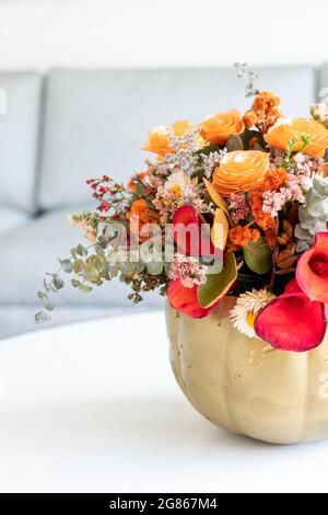 Floral arrangement of roses inside pumpkin decorated for a different Halloween Stock Photo