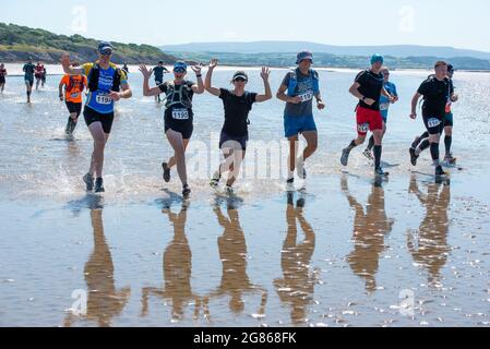 Silverdale, Carnforth, Lancashire, UK. 17th July, 2021. A hot start for the runners in the Rat Race Man vs Lakes event as they set off over Morecambe Bay from Silverdale, Lancashire heading towards the finish at lake Coniston in the Lake District up to 30 miles later. Credit: John Eveson/Alamy Live News Stock Photo