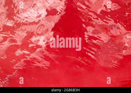 Red abstract background liquid movement concept glossy surface Stock Photo