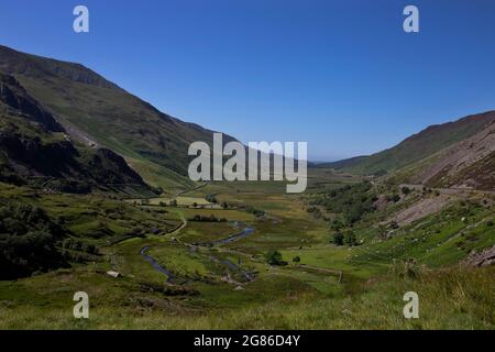 Nant Ffrancon Valley and pass with Afon Ogwen winding through it and the A5 road on the right hand side.  Part of Snowdonia National Park in North Wal Stock Photo