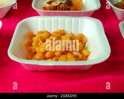 Gram flour Indian traditional sweet balls presented on white disposal plate. Stock Photo