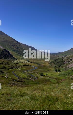 Nant Ffrancon Valley and pass with Afon Ogwen winding through it and the A5 road on the right hand side.  Part of Snowdonia National Park in North Wal Stock Photo