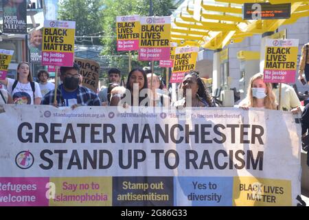 Manchester, UK.  17th July 2021. A lively and vocal Black Lives Matter protest of some 120 people marched from St Peter's Square to the Football Museum in central Manchester. This follows the online racist abuse of black footballers in the England football team, with the protest having a theme of solidarity with England football players: Marcus Rashford, Bukayo Saka and Jadon Sancho. The group took the knee in the road by the Football Museum, blocking the traffic for 20 minutes. Credit: Terry Waller/Alamy Live News Stock Photo