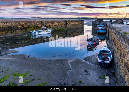 A beautiful sunset at the small harbour at Beadnell, the only west-facing harbour on Northumberland's coast, England, Uk Stock Photo