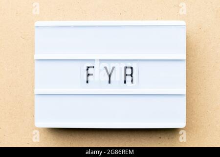 White lightbox with word FYR (abbreviation of for your reference) on wood background Stock Photo