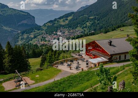 Aerial Panorama View with a Hotel Resort and Mountains in the Background - Jungfrau Region, Wengen, Switzerland Stock Photo